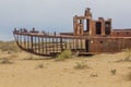 Rusty abandoned ship at the Ship cemetery at the former Aral sea coast in Moynaq Mo ynoq or Muynak , Uzbekist Royalty Free Stock Photo