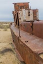 Rusty abandoned ship at the Ship cemetery at the former Aral sea coast in Moynaq Mo ynoq or Muynak , Uzbekist Royalty Free Stock Photo