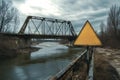 Old rusty abandoned train bridge crossing river with warning sign Royalty Free Stock Photo