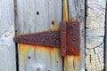 Rusty aged iron hinge weathered gray wood door Royalty Free Stock Photo