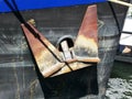 Rusty anchor on the side of a boat