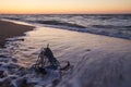 RUSTY ANCHOR WET BEACH SAND AND WHITE SEA-WAVE FOAM Royalty Free Stock Photo