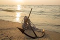 RUSTY ANCHOR WET BEACH SAND AND WHITE SEA WAVE FOAM Royalty Free Stock Photo