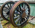 Rusty antique wheel next to river. Royalty Free Stock Photo