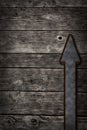 Rusty arrow on wooden background Royalty Free Stock Photo