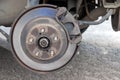 Rusty back car wheel hub with brake disc at tire shop. Car without a wheel while replacing on the tire service center