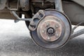 Rusty back car wheel hub with brake disc at tire shop. Car without a wheel while replacing on the tire service center