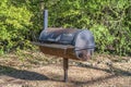 Rusty barbeque grill against lush green foliage at Bull Creek Austin Texas