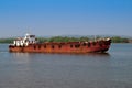 A rusty barge on a river