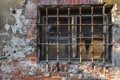 Rusty bars on the window old building ruin, damaged brick wall Royalty Free Stock Photo