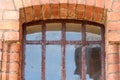 Rusty bars on the windows of old antique buildings. Historical and cultural values. Red brick wall. Restoration of a castle or Royalty Free Stock Photo