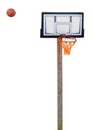 Rusty basketball hoop with ball in midair