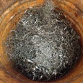 Rusty bin with shiny stainless steel metal swarf filings in an i