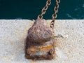 rusty bitt in the harbor of Ibiza on a sunny day whit a chain Royalty Free Stock Photo