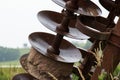 Rusty blades of farm equipment in a field Royalty Free Stock Photo