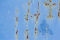 A rusty blue metal wall with fallen paint, a rusty background Royalty Free Stock Photo