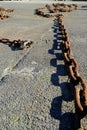 rusty boat chain on the tarmac Royalty Free Stock Photo