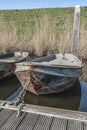 Rusty boat lying in a small lake Royalty Free Stock Photo