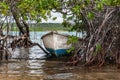 A rusty boat moored at mangrove trees on the shore of St Joris Bay in Curacao