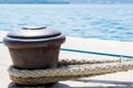 Rusty Boat Mooring on a Harbour Wall with Rope Attached