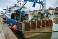 Rusty boat and nets for catching scallops Royalty Free Stock Photo