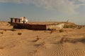 Rusty boat shell lying in the desert Royalty Free Stock Photo