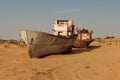 Rusty boat shell lying in the sand Royalty Free Stock Photo