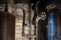 Rusty boiler room pipes. Old metal boiler generating heating and delivering it to home through pipeline. Hot water or gas is being