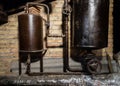 Rusty boiler room pipes. Old metal boiler generating heating and delivering it to home through pipeline. Hot water or gas is being