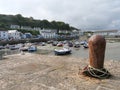 Rusty bollard, blojen and ropes of fishermen in the harbour of Porthleven