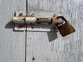 Rusty bolt with padlock on an old door Royalty Free Stock Photo