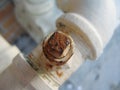 Rusty bolt on water pipe