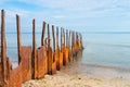 Rusty breakwater with the sea in the background