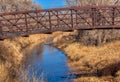 Rusty bridge over stream Royalty Free Stock Photo