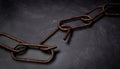 Rusty broken chain, on dark Royalty Free Stock Photo