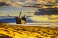 Rusty broken shipwreck on sea shore