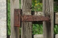 rusty brown door hinge on gray wooden door boards Royalty Free Stock Photo