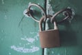 Rusted padlock on a green door