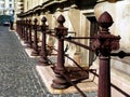 Rusty brown red old weathered cast iron railing along stone facade Royalty Free Stock Photo