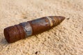 Rusty bullet on a sand