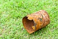 Rusty can on green grass