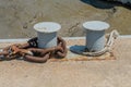 Rusty chain around metal dock cleat Royalty Free Stock Photo