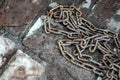 Rusty chain on the brickwork. The symbol of slave labor Royalty Free Stock Photo