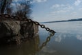 Rusty chain entering the waters of the danube river in Belgrade, Serbia Royalty Free Stock Photo