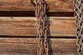 Rusty chain hanging on wooden wall Royalty Free Stock Photo