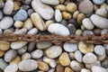 Rusty chain laid on pebbles, Chesil beach, Weymouth, Dorset Royalty Free Stock Photo