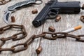 A rusty chain lies snake with cigarettes on a wooden background. Top view from an angle close-up