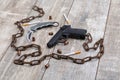 A rusty chain lies snake with cigarettes on a wooden background. Top view from an angle