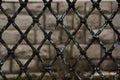 Rusty Chain Link Fence on gray background, gray and black abstract closeup of a chain link background