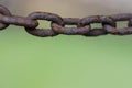 Rusty chain links close up macro shot on green natural background Royalty Free Stock Photo